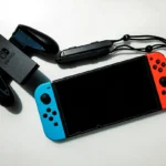 white nintendo switch beside black usb flash drive
