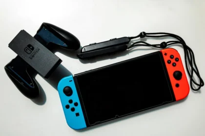 white nintendo switch beside black usb flash drive