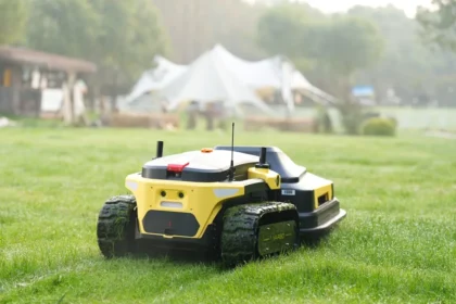 Robot lawnmower cuts grass in a backyard.