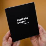 A person holding a black box with the samsung logo on it