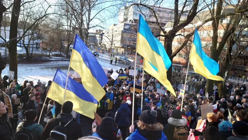 a group of people holding flags in a park