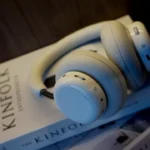 White headphones resting on books
