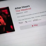 black flat screen tv turned on displaying man in black suit