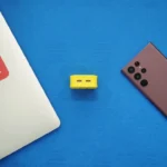 a yellow object next to a gray object on a blue surface