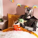 a child in a star wars costume reading a book