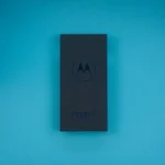 a motorola cell phone sitting on top of a blue table