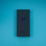 a motorola cell phone sitting on top of a blue table
