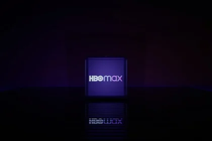 Hbo max logo on a dark reflective surface.
