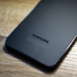 a close up of a samsung phone on a wooden table