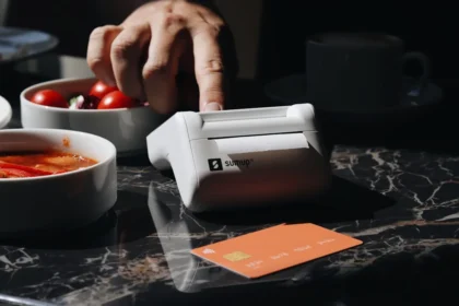 A person using a machine to cut tomatoes