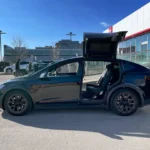 a car with its door open in a parking lot