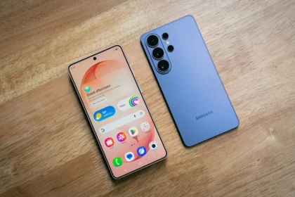 Two smartphones displayed on a wooden surface.