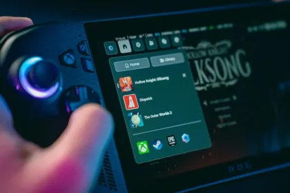 Hand holding a gaming device with game menu