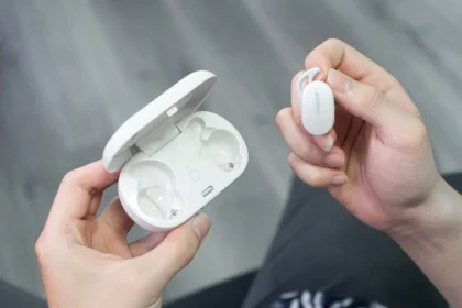 a person holding a white device in their hands