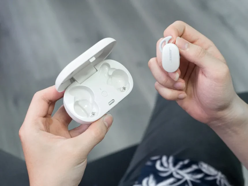a person holding a white device in their hands