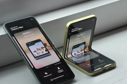 Two cell phones sitting next to each other on a window sill
