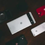 a group of cell phones sitting on top of a wooden table