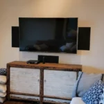 a living room with a fireplace and a flat screen tv