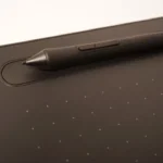 a pen is sitting on top of a tablet