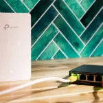 A wi-fi router and a network switch sit side-by-side.